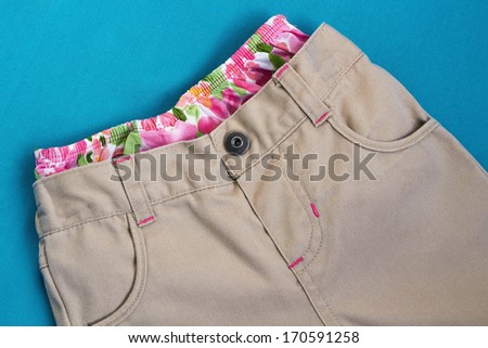 Girl\'s  trousers with  underpants inside on a blue background