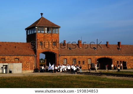 OSWIECIM, POLAND - September 12: Auschwitz Camp, a former Nazi extermination camp on September 12, 2013. High school students from Israel are taking pictures in front of the gate.