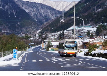 GIFU, JAPAN- March 3: The local bus driving through a small village that is covered with snow on March 3, 2014. Low birthrate and longevity is considered as a serious problem in local area of Japan.