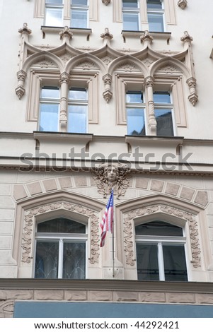 Richly decorated facade with American flag of Pariz hotel in Prague