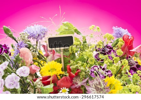 a close up of a bouquet of flowers with a black label (copy space) and a magenta gradient background