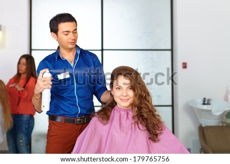 Hair salon. Woman haircut. Spraying.