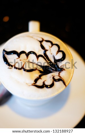 Cup of cappuccino with flower sign