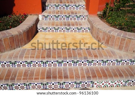 Courtyard of mediterranean villa with ceramic tile walkway  and steps in Egypt