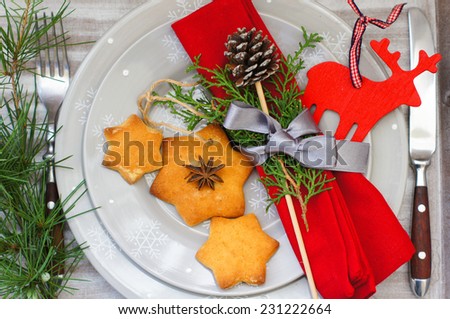 Christmas time table decoration with rose hips and tea with christmas tree branches