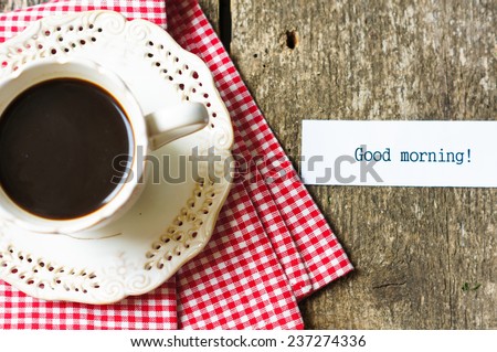 Cup of black tea with orange and good morning note