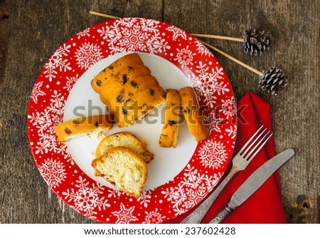 Christmas cake with spices, cinnamon and anise star,on th ered snowflake ornament plate