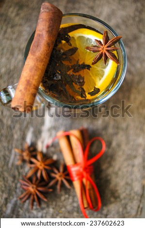 Christmas time, cup of tea with cinnamon and anise spices, festive decoration and candles