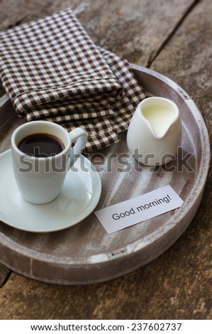 Cup of black coffee with milk and Good morning note