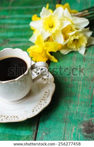 Cup of coffee, easter eggs and bunny on the old wooden table