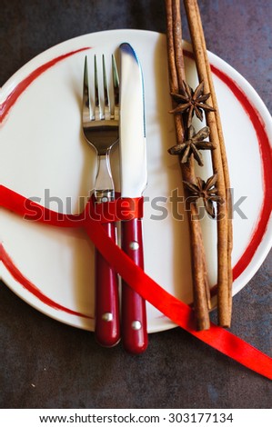 Table set for celebration St. Valentine\'s Day with red ribbin on dask stone background
