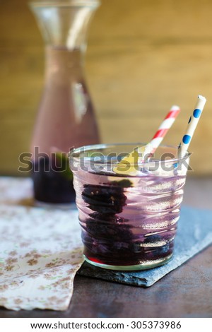 Lemonade with fresh berries and lime, vintage style. Selective focus