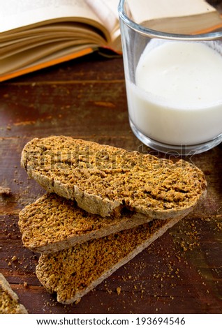 Fresh baked chocolate-coffee biscottis with poppy seed on wooden background