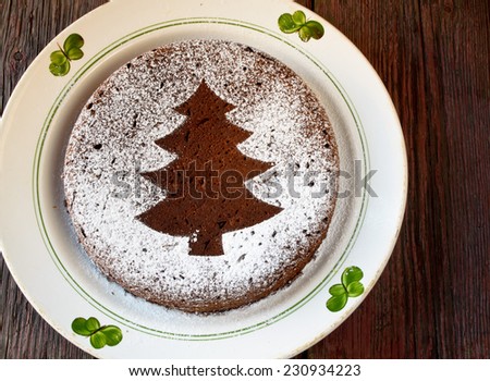 Homemade chocolate Christmas cake sprinkled with sugar powder