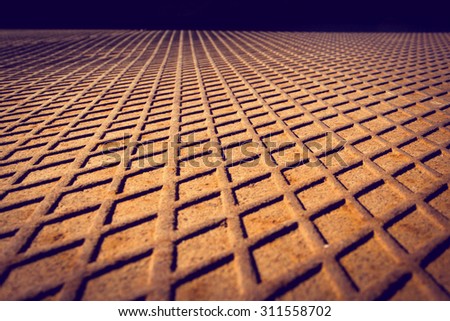 Rusted metal floor with a diamond-shaped pattern. Abstract background