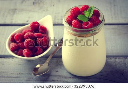 Healthy breakfast - fresh Greek yogurt with raspberries and mint in a glass