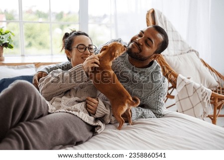 Similar – Image, Stock Photo Young couple playing with their soon at home.