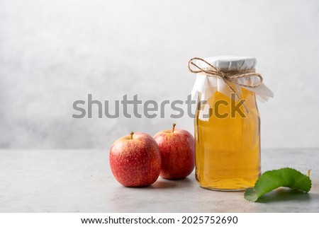 Similar – Image, Stock Photo Homemade apple vinegar in bottle with apples and green leaves on white background. Top view