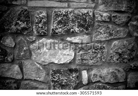 stone wall texture faded with white stone in black and white