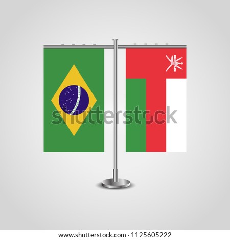 Table stand with flags of Brazil and Oman.Two flag. Flag pole. Symbolizing the cooperation between the two countries. Table flags
