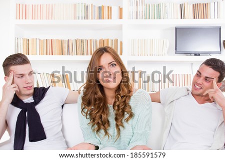 undecided pretty confused woman choosing between two young men