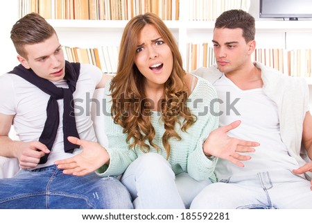 unsure and doubtful beautiful woman hesitates between two young men