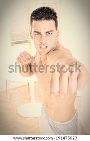 determined man fighter punching showing his fist, training punch with clenched fists