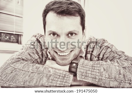 Portrait on a nice looking man with a toothy smile. Vintage black and white effect style