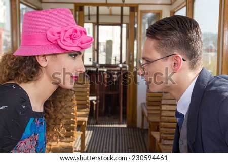 serious man in suit in the wagon train  with angry  woman look at each other face to face ,couple argument on train , vintage retro fashion photo