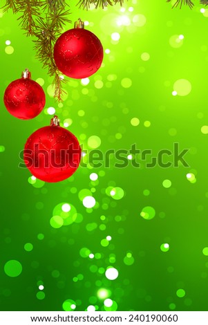 Christmas red balls with green fir tree on colorful green bokeh background. New Year greeting card. Xmas Decorations. Sparkles and bokeh. Shiny and glowing copyspace, place for text and advert.