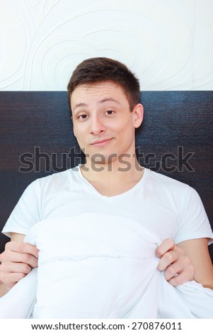 Proud man sure in himself showing his strong penis erection under sheets . Size matters . Provocative man calling for sex satisfied with his potency