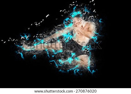 Athletic boxer fighter performing a flying side kick isolated on white background