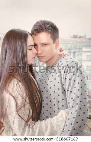 Loving young couple tenderly embracing touching foreheads and noses , Boyfriend and girlfriend in love hugging nose to nose