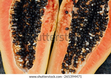 sliced papaya fruit on black background