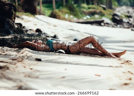 young beautiful woman in bikini on sand beach background. sexy woman on the tropical beach. woman on beach with tropical suntan in virgin islands. Woman in bikini at tropical beach.