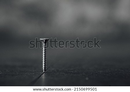 partially screwed screw wood dark background Photo stock © 
