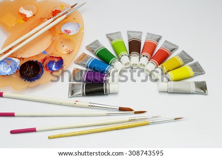 colors and paint brushes on paper art