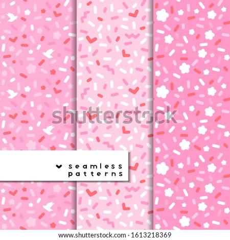 Set of  Saint Valentine's Day seamless patterns with particles: dots, zig-zags, rounded stick, hearts, doves and flowers. Rose, white and red colors and tints. Repeatable stock illustration in vector