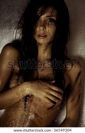 sexy model with wet and dirty skin and hair taking a shower