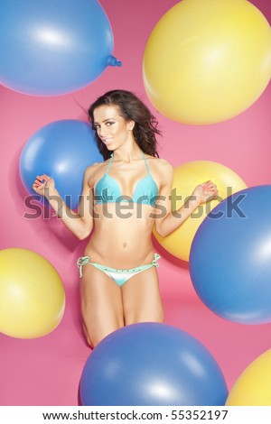 sexy bikini brunette girl holding balloons .