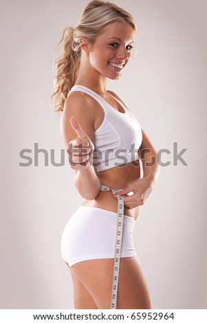 Woman measuring perfect shape of beautiful thigh. Healthy lifestyles concept