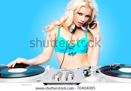 Beautiful DJ girl on decks on the party,blonde model on aqua blue background