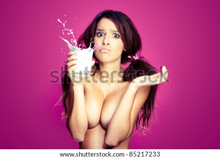 Portrait of a beautiful brunette topless woman drinking milk