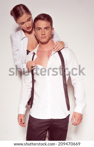 Fashion Photo Shoot. Very Handsome Guy in Fashion Attire Together with Partner, Isolated on Gray.