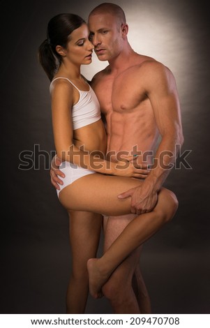 Very Sexy Young Partners Showing Seductive Pose Flaunting Nice Body Curves and Lines. Isolated on Gray Background