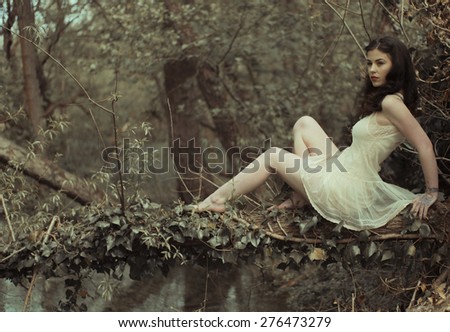 Sensual Woman in White Dress Posing at the Woods