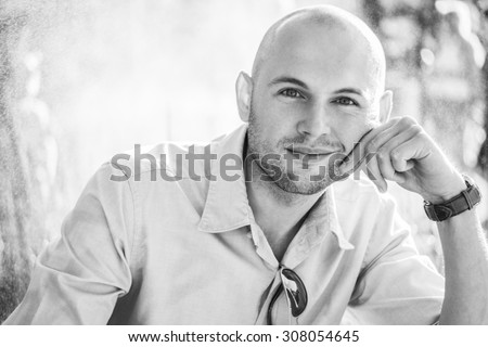 fashionable male model looking at the camera wearing shirt and watch