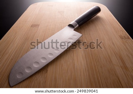 japanese kitchen knife on a bamboo chopping board