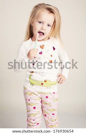 funny little girl  with tooth brush
