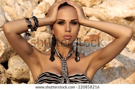 fashion outdoor portrait of sexy woman with dark hair in bikini with accessories
